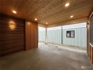 Large covered patio is private and features a beautiful wood feature wall. This is a space that could be used year-around. Fence & landscaping not installed yet.