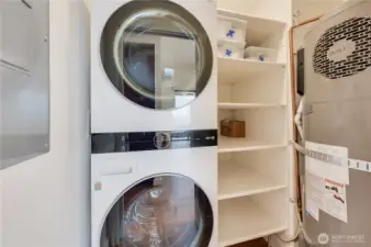 The utility room with newer, fabulous stack washer & dryer plus a new 2024 water heater.