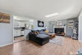 Open living space with fireplace and natural light.