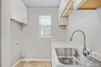 Large laundry room with plenty of countertop and storage space
