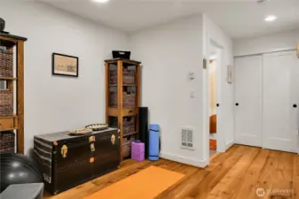 View to the hallway, workout space, bathroom, and utility closet on lower level.