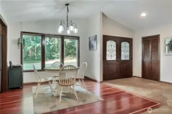 Formal dining area adjacent to the double door entry with large windows connecting you to the outdoors.