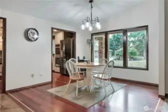 Another view of the dining area adjacent to the kitchen. Notice the inlaid accents in the hardwood floors.