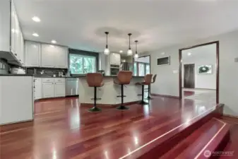 The spacious open kitchen boasts an island, granite counters, double ovens, and a beverage fridge; it’s a culinary enthusiast's paradise.