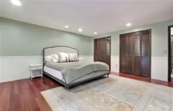 The primary suite features two-tone wainscoted walls and dual closets.
