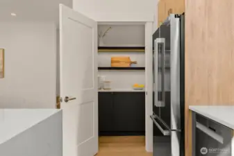 Designer kitchen with custom walk-in pantry.