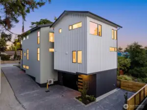 Oversized 2 car garage with abundant storage + 1 designated parking space for ADU. Rear exterior showcasing SFR + ADU.