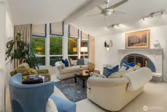 This living area exudes harmony and refinement—an ideal blend of sophistication and ease. A perfect spot to unwind by the fire or enjoy the glow of the treetops outside the soaring windows.