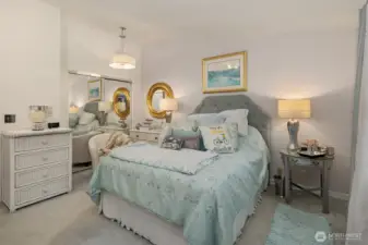 A tranquil retreat filled with soft natural light and peaceful ambiance. The primary suite features a elegant lighting evokes a sense of calm and relaxation. Mirrored closet doors add a level of sophistication. An inviting blend of comfort and elegance designed for restful nights and quiet mornings. ?????