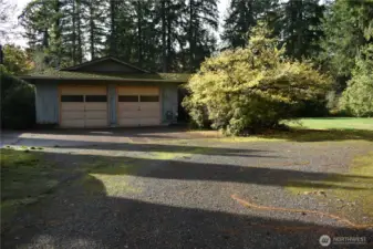Driveway view of the home. This home has been perfectly placed on the .96 of an acre lot so you have "privacy plus". Fenced and gated back yard offers open space for play area, big toy, dog run, garden beds and more.