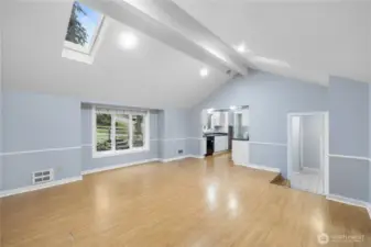 Large vaulted living room with skylights