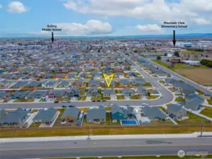 AERIAL VIEW LOOKING SOUTH: Home Sits on a Bend in the Road to the West, Naturally Slowing Traffic; Nearby Schools to the Southwest and Southeast