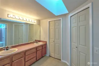 Primary bath with double vanity, large walk-in closet and skylight.