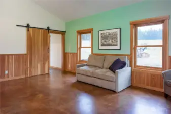 Main floor, entryway to back door, bathroom, storage bay and kitchen