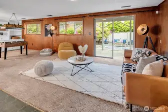 Lower level Rec Room with beautiful wood paneling and walk-out slider to patio and mature gardens