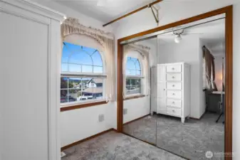 Large mirrored closet off primary bedroom and partial water view