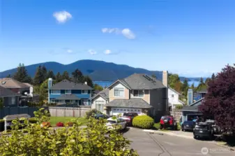 view from the front of the house, of the quiet neighborhood and cul-de-sac.  plus filtered view of the sound.