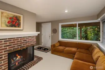 Lower level has comfortable living space with a warm cozy fireplace. This level offers a separate entrance and could be an ADU for rental income or multi-generational living.