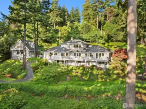 Impeccable landscape surrounds the home.