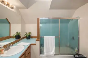 Nice bath has a large vanity with ample storage below.