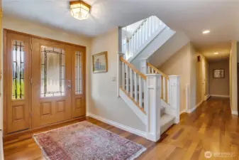 A solid wood door flanked by sidelights welcomes you to the hardwood entry on the main floor. The large hall closet is convenient for storing coats and shoes.