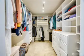 The walk-in closet is all set with a complete closet organizer and a built-in dresser to keep clothes, shoes, and accessories organized.
