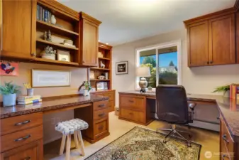 Find this office, complete with built-in desks and cabinetry, overlooking the front garden at the other end of the main floor hallway.