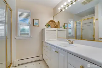 This 3/4 ensuite bath offers a tiled shower and a vanity with plenty of cupboards and drawers for storage.