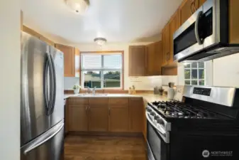 The beautifully remodeled kitchen features stainless steel appliances, newer cabinets, and gas cooking!