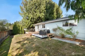Fully fenced backyard with garden space perfect for entertaining, pets, and playtime!