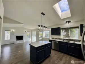 Great open floor plan leading from kitchen into dining area.
