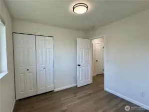 Second bedroom with vinyl plank flooring.