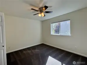 Third room overlooks greenbelt and has nice carpet and ceiling fan.