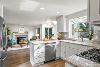 Kitchen has granite counters and full height tile backsplash