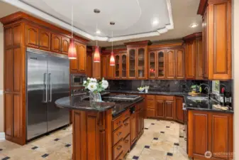 Spacious open kitchen with quality viking appliances, granite countertops and warm cherry cabinetry