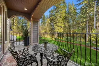 Private master retreat balcony finished in tile and wrought iron overlooks the grounds