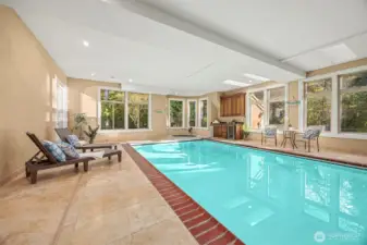Indoor pool with shower, half bath and pool bar