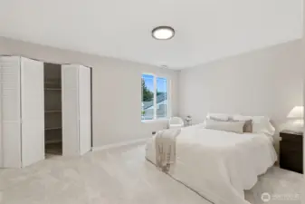 Spacious primary bedroom with natural light