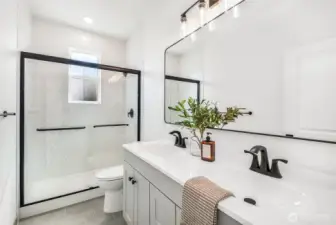 Beautifully finished bathroom with tile floors and tile surround!