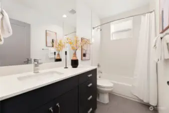 Stylish and functional, this second-floor full bathroom boasts modern finishes, sleek tile work, and plenty of light—because even bathrooms deserve a touch of luxury.