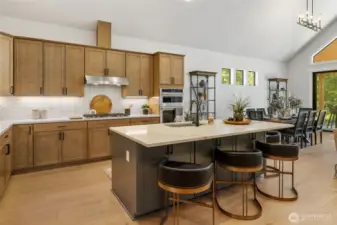 Gourmet kitchen with gas cooktop and stainless steel extraction hood.