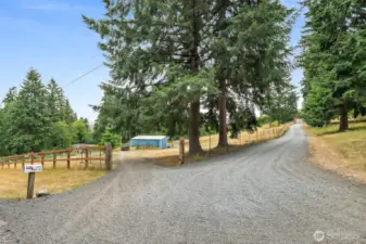Road access to Barn and Pastures. Private Drive to House and Shop to the right.