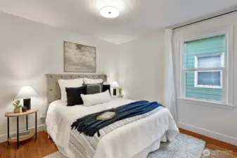 One of two bedrooms on the main level, with hardwood floors and cedar-lined closets.