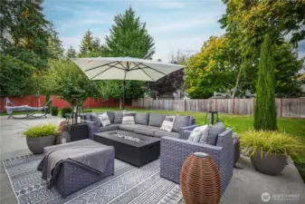 The expanded patio is perfect for entertaining or relaxing, with a fully fenced yard beyond.