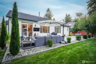 Professionally designed landscaping creates a refined backyard retreat.