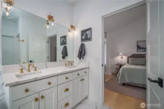 Dual vanities, quartz counters, bronze fixtures, and heated floors add luxury.