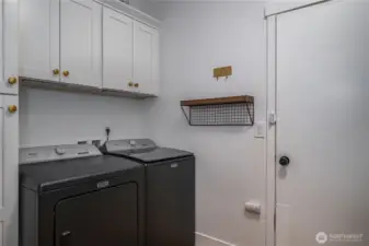 The laundry room boasts extra storage and access to the oversized 3-car garage.