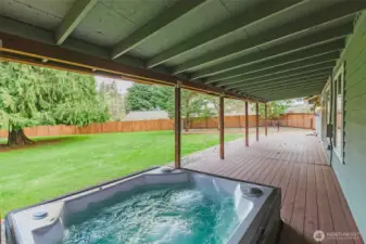 covered deck with spa