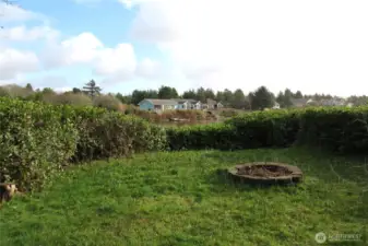 TO THE RIGHT OF THE PROPERTY IS AN EXISTING FIR PIT TO ENJOY HOT DOGS OR SMOORES!