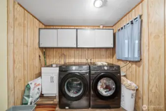 Main level laundry room with sliding barn doors for entry